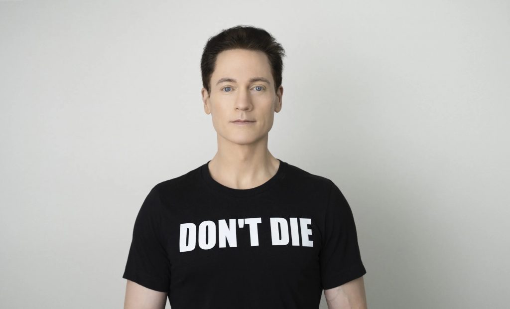 Bryan Johnson wearing a "don't die" shirt. 