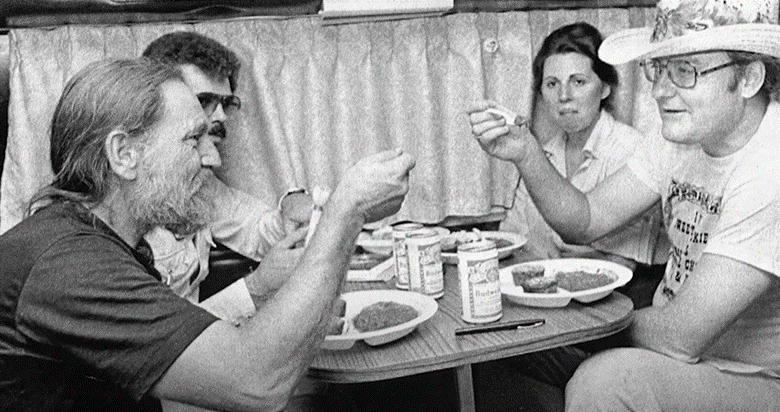 Willie Nelson enjoying food with country music fans