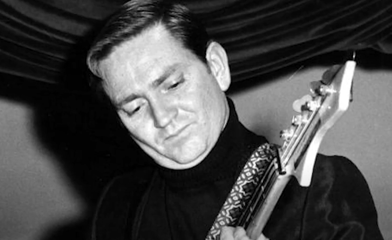 Willie Nelson playing a guitar in his younger years (date of photo unknown)