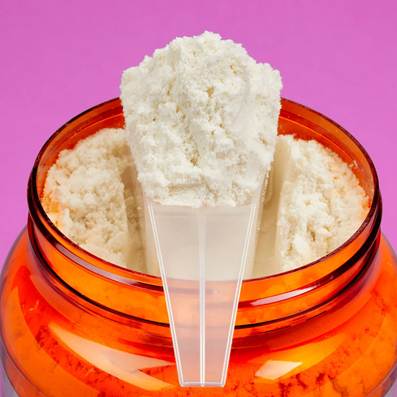 An image of a protein supplement extracted from a bottle with a scooper