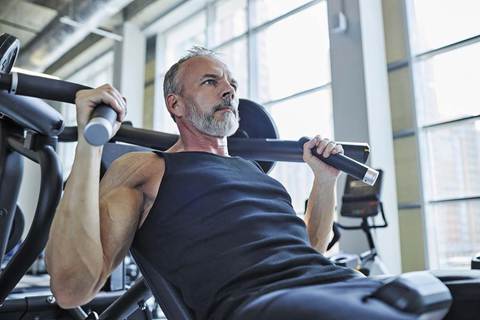 A man doing a resistance training exercise using a machine