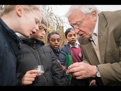 An image of David Attenborough teaching young students